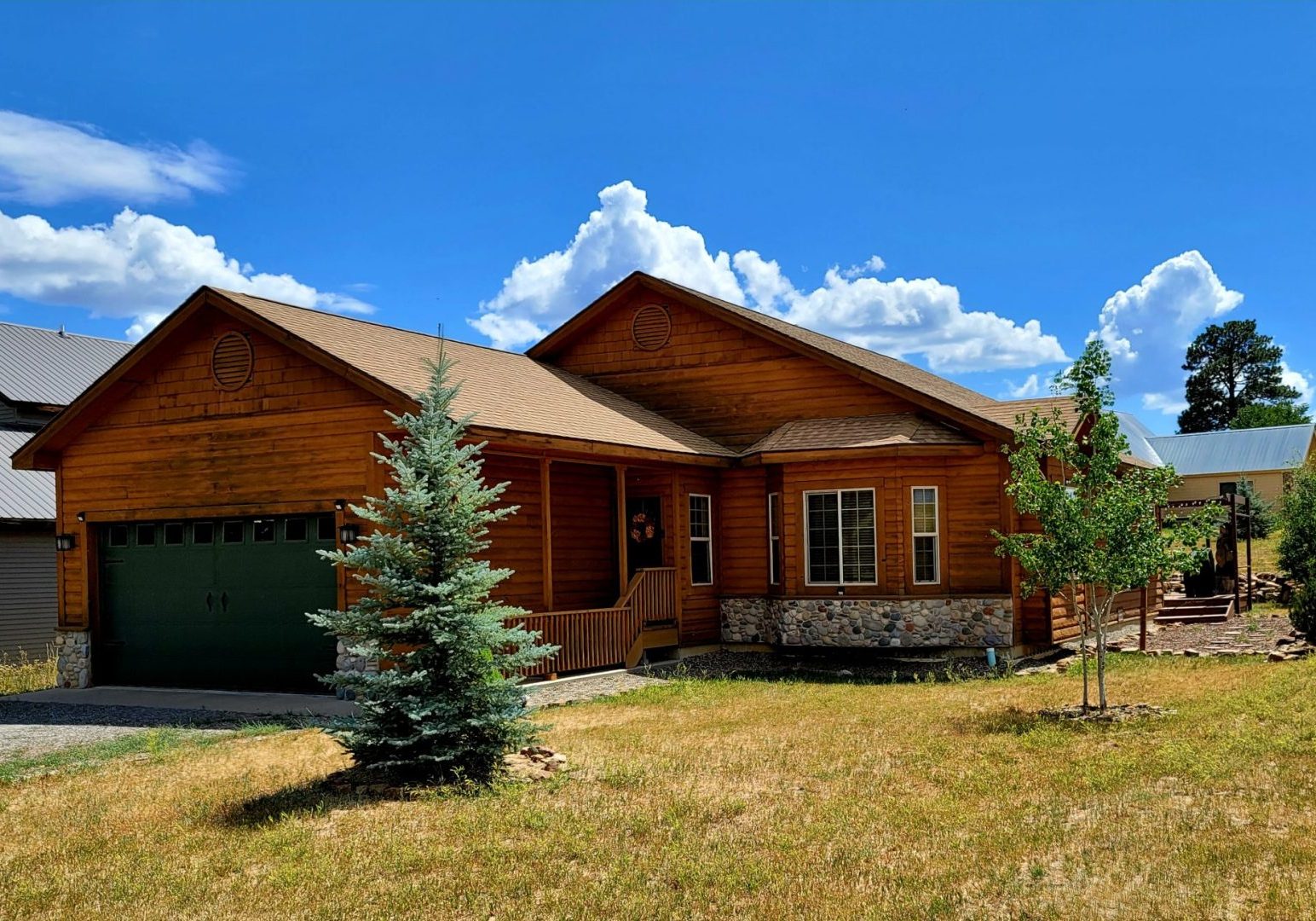 A brown house in a grassy area.